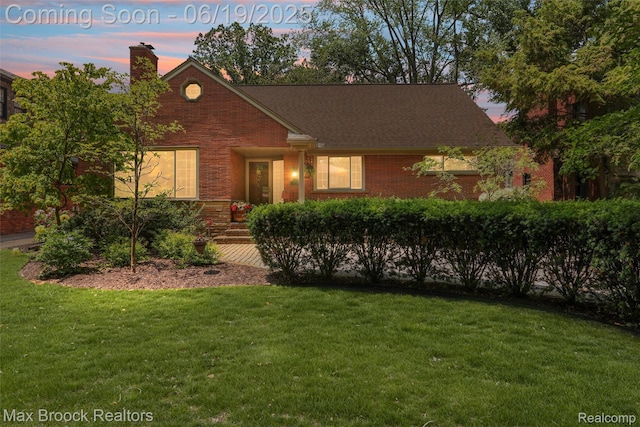 25845 Salem Rd, Huntington Woods, MI 48070 - view of front of home with brick siding, a front lawn, and a chimney