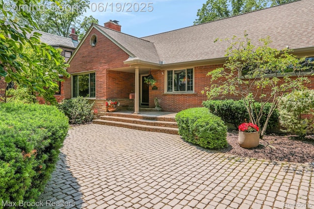 25845 Salem Rd, Huntington Woods, MI 48070 - view of front of house with brick siding, a chimney, and roof with shingles