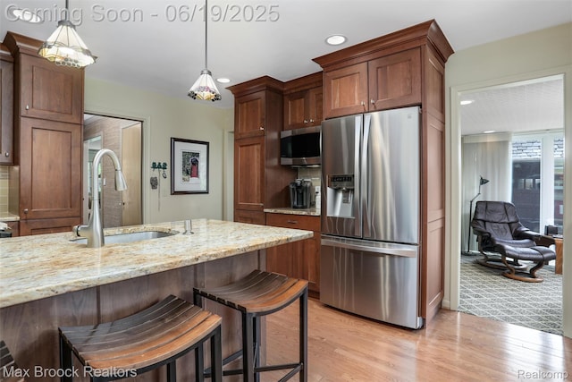 25845 Salem Rd, Huntington Woods, MI 48070 - kitchen with stainless steel appliances, light stone countertops, pendant lighting, recessed lighting, and light wood-style flooring