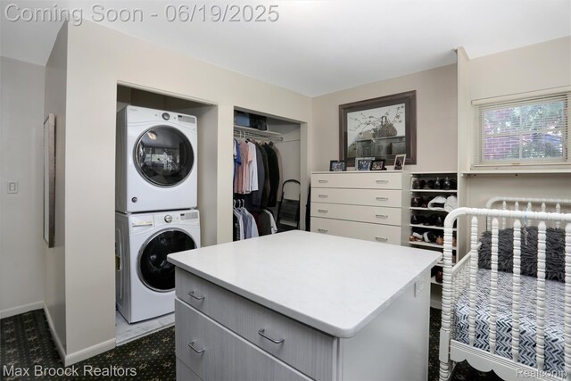 25845 Salem Rd, Huntington Woods, MI 48070 - laundry room featuring stacked washer and clothes dryer and baseboards