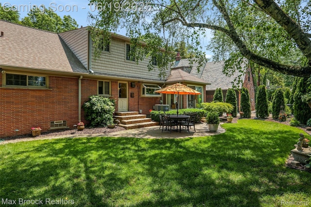 25845 Salem Rd, Huntington Woods, MI 48070 - back of property with a lawn, brick siding, and a patio