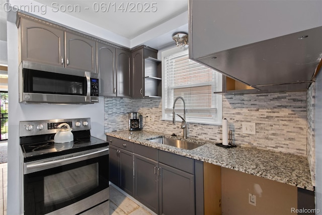 16136 Whitcomb St, Detroit, MI 48235 - kitchen with appliances with stainless steel finishes, decorative backsplash, light stone counters, open shelves, and gray cabinets