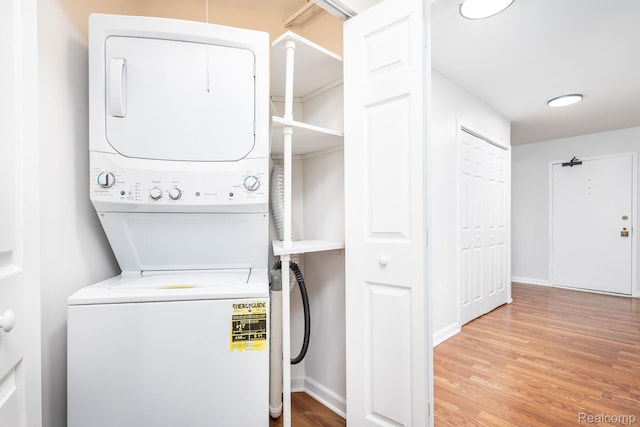 5000 Town Ctr Unit 2001, Southfield, MI 48075 - laundry room featuring stacked washer and clothes dryer and wood finished floors
