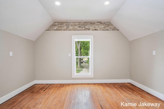 947 W Main St, Ionia, MI 48846 - additional living space featuring vaulted ceiling, wood-type flooring, and recessed lighting