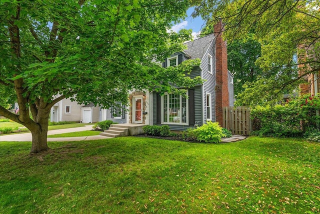 1115 Keneberry Way SE, East Grand Rapids, MI 49506 - view of front of home featuring driveway, an attached garage, and a chimney