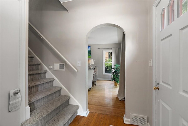 1115 Keneberry Way SE, East Grand Rapids, MI 49506 - foyer with arched walkways, wood finished floors, and stairs