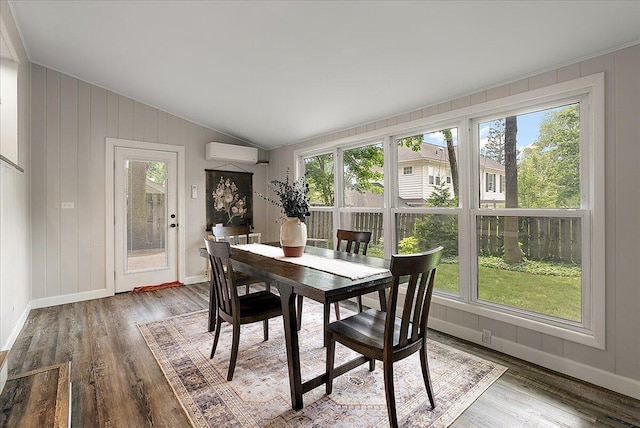 1115 Keneberry Way SE, East Grand Rapids, MI 49506 - dining space featuring a wall unit AC, lofted ceiling, healthy amount of natural light, and wood finished floors