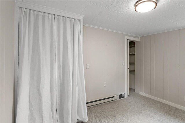 1115 Keneberry Way SE, East Grand Rapids, MI 49506 - empty room featuring a baseboard radiator, carpet, and crown molding