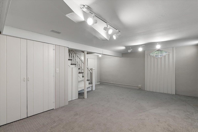 1115 Keneberry Way SE, East Grand Rapids, MI 49506 - basement with carpet, stairway, and rail lighting