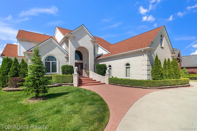 13205 Van Pamel Dr, Shelby Twp, MI 48315 - view of front of house featuring brick siding, a front lawn, and roof with shingles