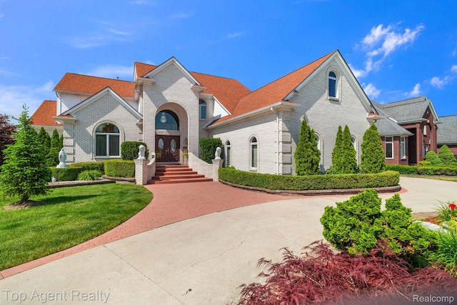 13205 Van Pamel Dr, Shelby Twp, MI 48315 - view of front of property with brick siding, a front lawn, and curved driveway