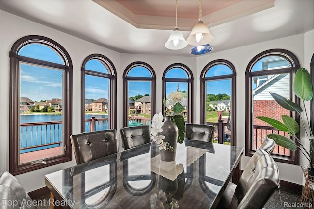 13205 Van Pamel Dr, Shelby Twp, MI 48315 - dining room featuring a raised ceiling, a water view, a chandelier, and a residential view