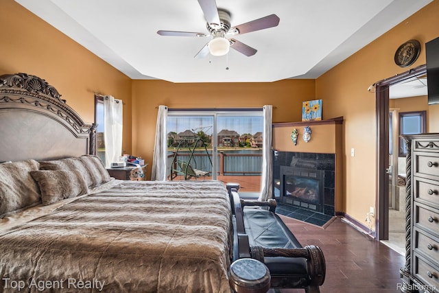 13205 Van Pamel Dr, Shelby Twp, MI 48315 - bedroom featuring access to outside, a fireplace, wood finished floors, and a ceiling fan