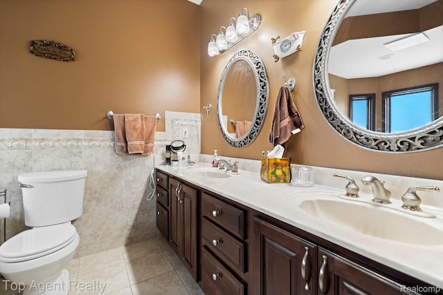 13205 Van Pamel Dr, Shelby Twp, MI 48315 - full bath featuring double vanity, tile walls, a wainscoted wall, and tile patterned flooring