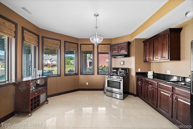 13205 Van Pamel Dr, Shelby Twp, MI 48315 - kitchen featuring stainless steel gas stove, under cabinet range hood, dark countertops, hanging light fixtures, and dark brown cabinets
