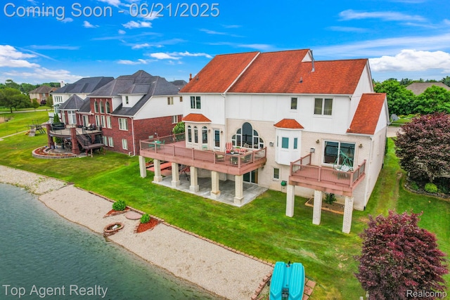 13205 Van Pamel Dr, Shelby Twp, MI 48315 - back of house with a deck with water view, a patio area, and a lawn