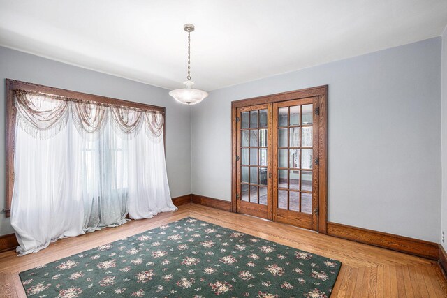106 E Mechanic St, Yale, MI 48097 - spare room with french doors and wood finished floors