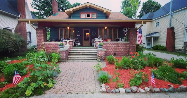 106 E Mechanic St, Yale, MI 48097 - view of front facade featuring covered porch, a chimney, and brick siding