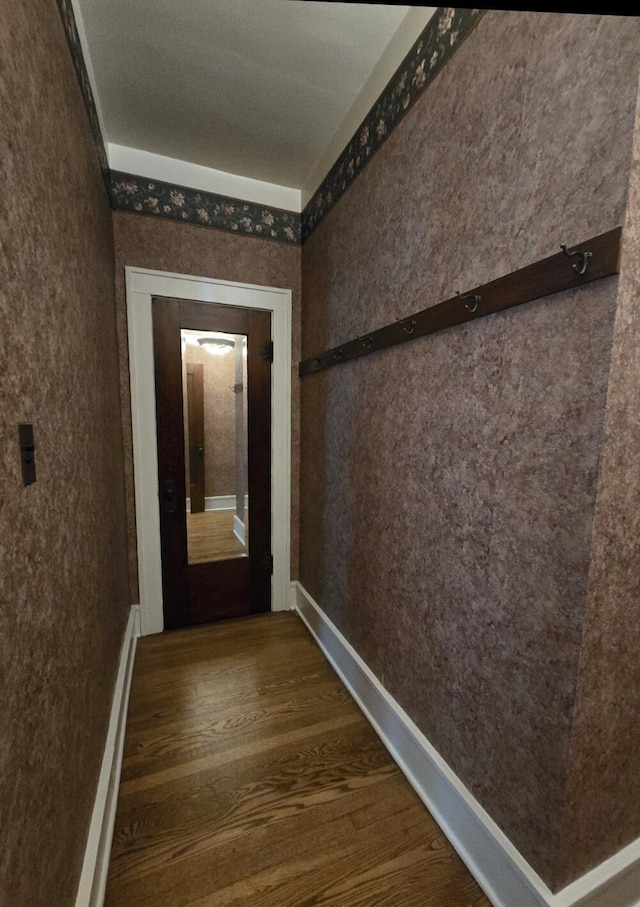 106 E Mechanic St, Yale, MI 48097 - hall featuring dark wood-style flooring and baseboards