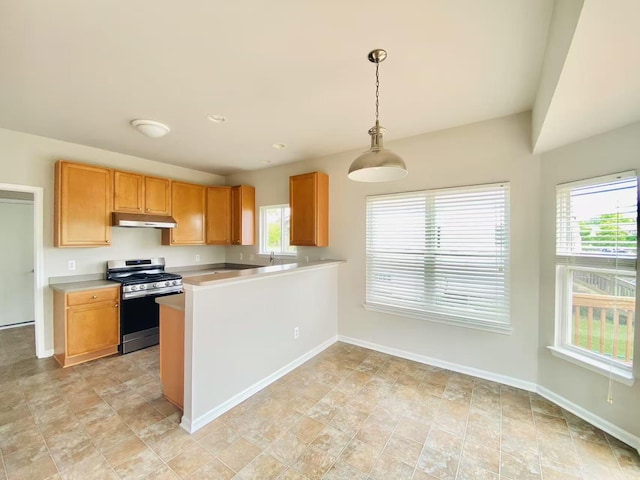 1924 Savannah Ln, Ypsilanti, MI 48198 - kitchen featuring stainless steel gas range oven, under cabinet range hood, light countertops, and healthy amount of natural light