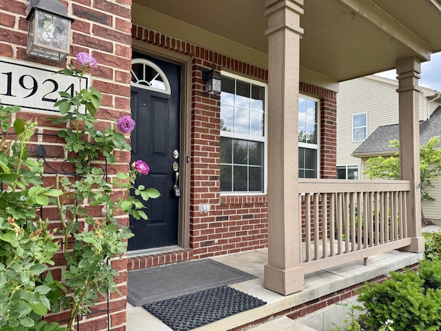 1924 Savannah Ln, Ypsilanti, MI 48198 - doorway to property featuring covered porch and brick siding