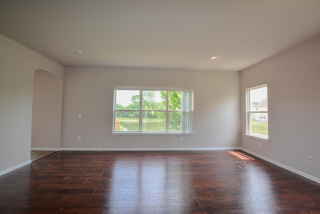 1924 Savannah Ln, Ypsilanti, MI 48198 - empty room featuring healthy amount of natural light, dark wood-style floors, arched walkways, and recessed lighting