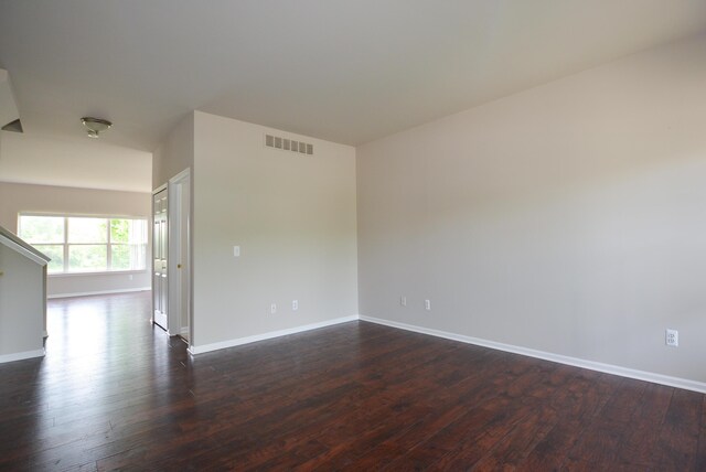 1924 Savannah Ln, Ypsilanti, MI 48198 - spare room featuring baseboards and dark wood-style flooring