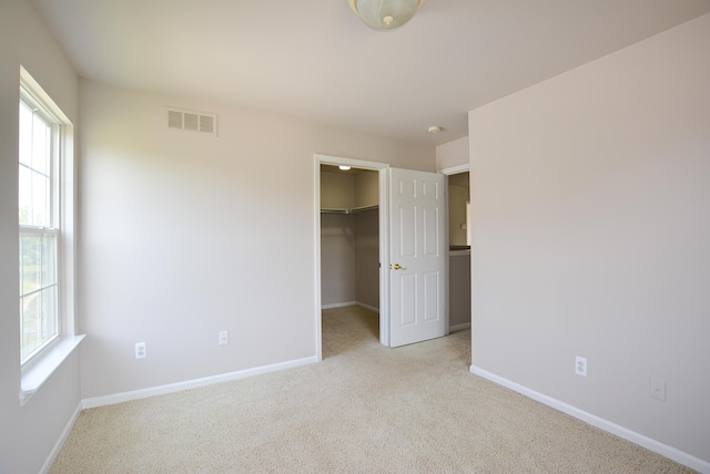 1924 Savannah Ln, Ypsilanti, MI 48198 - unfurnished bedroom featuring carpet, a walk in closet, and a closet