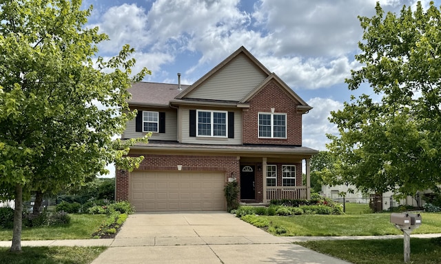 1924 Savannah Ln, Ypsilanti, MI 48198 - view of front of home with driveway, a garage, a front lawn, brick siding, and covered porch