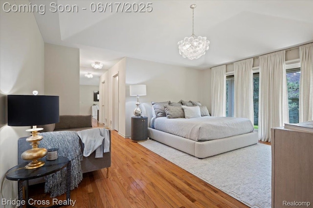 22025 Orchard Way, Beverly Hills, MI 48025 - bedroom with wood finished floors, a chandelier, and access to exterior
