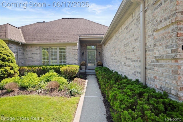22025 Orchard Way, Beverly Hills, MI 48025 - doorway to property with brick siding and a shingled roof