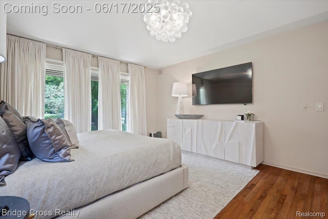 22025 Orchard Way, Beverly Hills, MI 48025 - bedroom with multiple windows, wood finished floors, and a chandelier