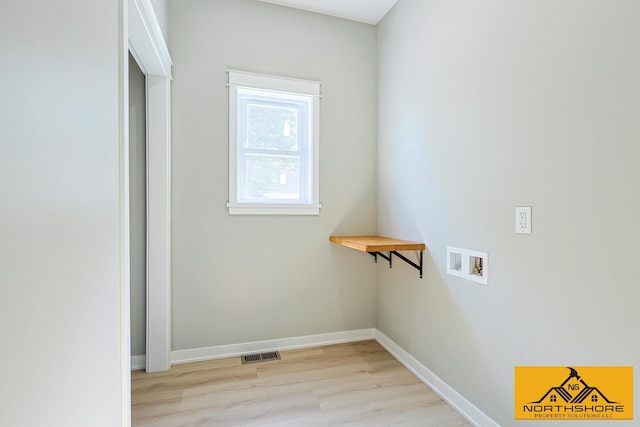 3973 W Harrison Rd, Hart, MI 49420 - washroom with washer hookup and light wood-type flooring