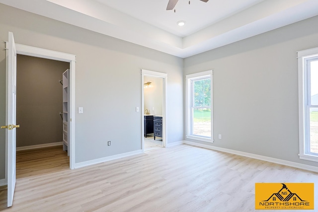 3973 W Harrison Rd, Hart, MI 49420 - unfurnished bedroom featuring light wood-type flooring, a walk in closet, recessed lighting, and a ceiling fan