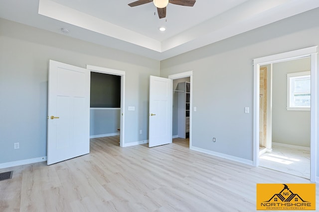 3973 W Harrison Rd, Hart, MI 49420 - unfurnished bedroom with a spacious closet, light wood-style floors, ceiling fan, a closet, and recessed lighting