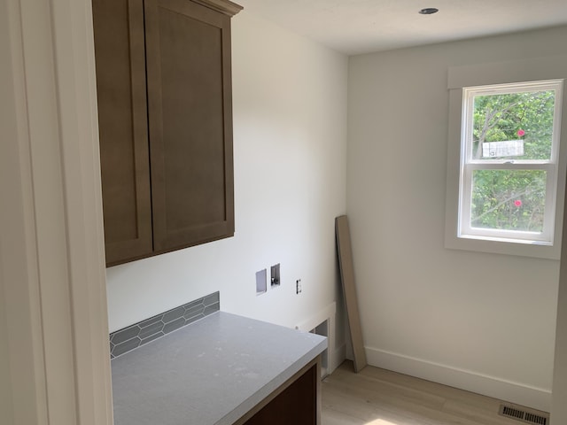 3094 Timberpine Ave, Holland, MI 49424 - washroom with light wood-style floors and cabinet space