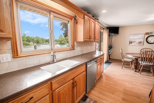 13278 W Stanton Rd, Trufant, MI 49347 - kitchen featuring stainless steel dishwasher, dark countertops, backsplash, light wood-type flooring, and recessed lighting