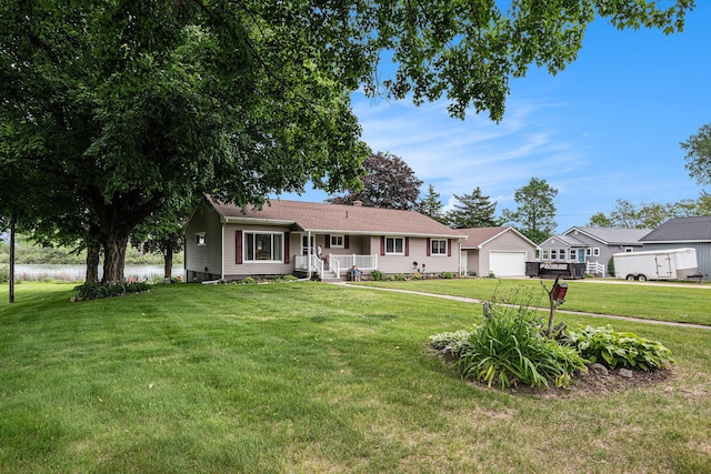 13278 W Stanton Rd, Trufant, MI 49347 - ranch-style house featuring covered porch, a front lawn, an outdoor structure, and a detached garage
