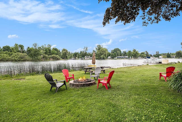 13278 W Stanton Rd, Trufant, MI 49347 - view of green lawn featuring a fire pit and a water view