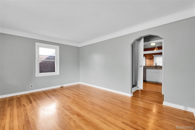 13513 Chestnut St, Southgate, MI 48195 - empty room featuring arched walkways and light wood finished floors