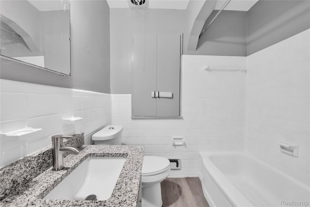 13513 Chestnut St, Southgate, MI 48195 - full bathroom with tile walls, vanity, wood finished floors, and wainscoting