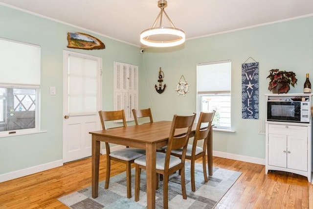 2885 Bluff St, Stevensville, MI 49127 - dining space featuring light wood-type flooring and crown molding