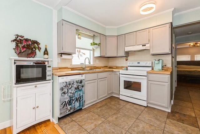 2885 Bluff St, Stevensville, MI 49127 - kitchen featuring white appliances, under cabinet range hood, tasteful backsplash, and crown molding