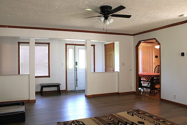 143 Tree Stand Rd, Rose City, MI 48654 - foyer with dark wood-style floors, ceiling fan, a textured ceiling, arched walkways, and ornamental molding