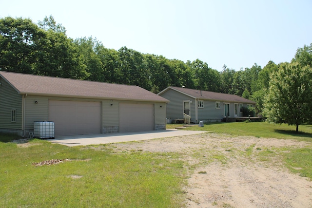 143 Tree Stand Rd, Rose City, MI 48654 - view of side of property featuring an outdoor structure, a detached garage, and a yard