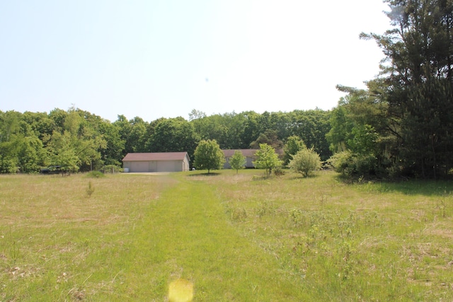 143 Tree Stand Rd, Rose City, MI 48654 - view of yard featuring a detached garage and a view of rural / pastoral area