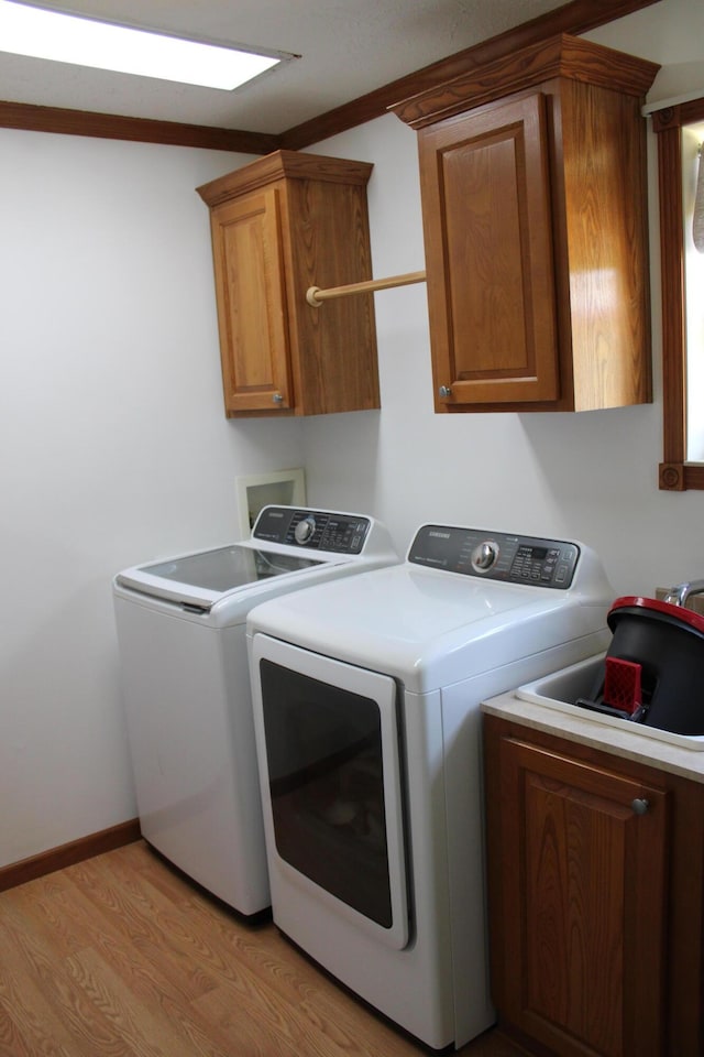 143 Tree Stand Rd, Rose City, MI 48654 - laundry area with cabinet space, independent washer and dryer, and light wood-style floors