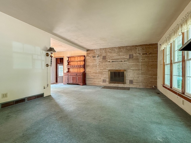 92359 Center St, Dowagiac, MI 49047 - unfurnished living room featuring a brick fireplace, plenty of natural light, and carpet flooring