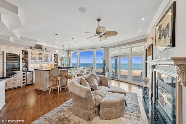 400 Lake Dr Unit C, New Buffalo, MI 49117 - living room with wine cooler, bar with sink, a premium fireplace, ornamental molding, and a water view