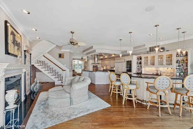 400 Lake Dr Unit C, New Buffalo, MI 49117 - living room with stairway, ornamental molding, a ceiling fan, wood finished floors, and a premium fireplace